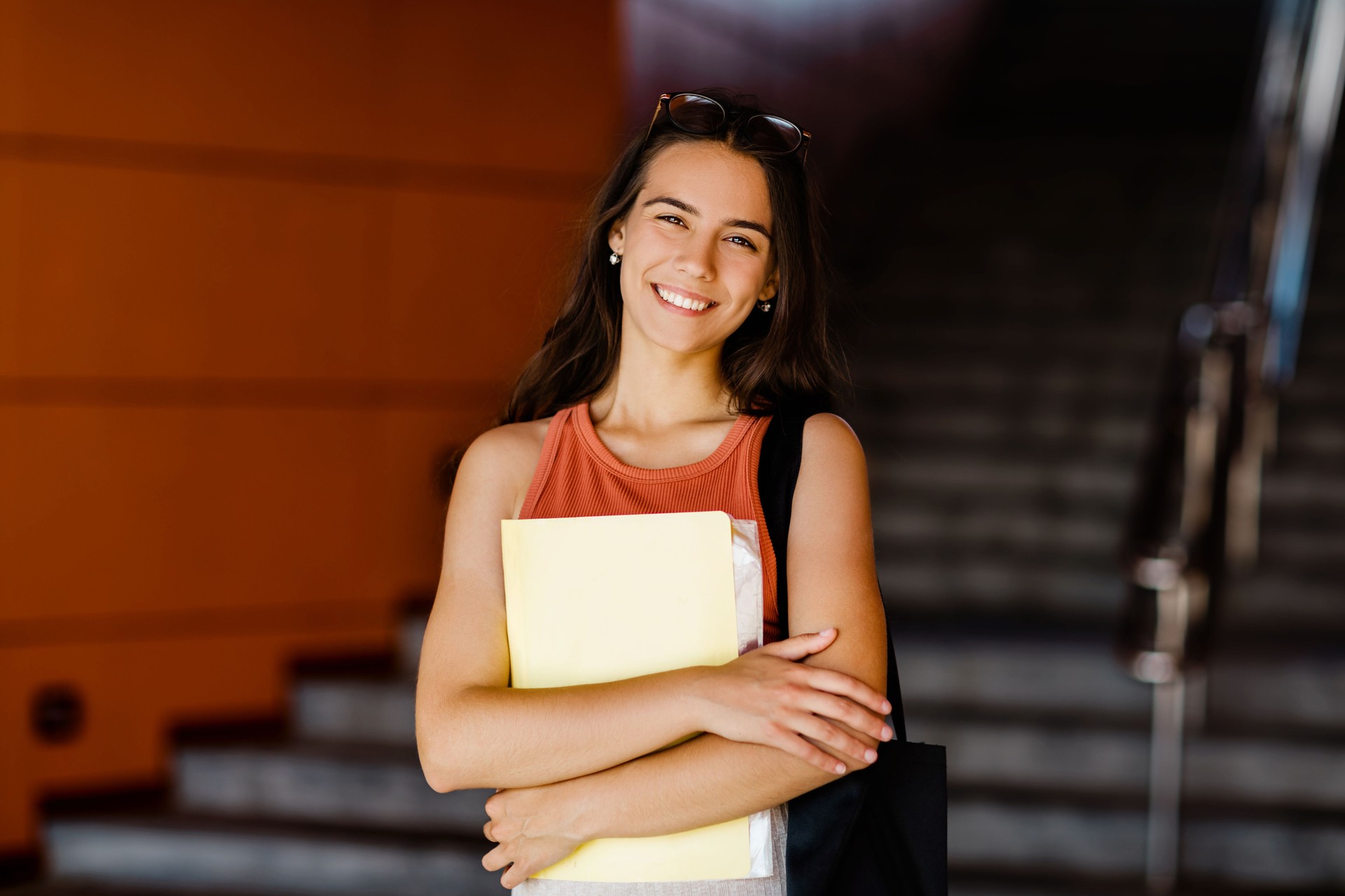 Portrait Of A Smiling Girl With A Folder In Her Hands